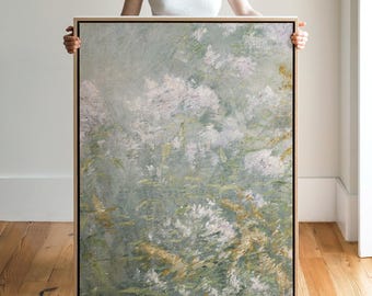 May include: A rectangular framed wall art piece featuring an impressionistic painting of soft white and pale pink floral clusters set against a muted sage green and earthy olive background with visible textured brushstrokes throughout the canvas.
