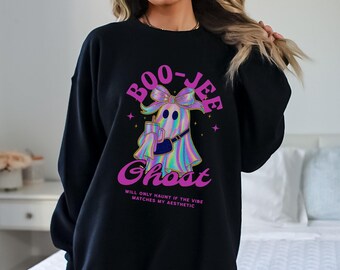 May include: Black sweatshirt featuring a cartoon ghost with a bow, holding a drink and purse. The text "BOO-JEE Ghost" is in pink, with the phrase "WILL ONLY HAUNT IF THE VIBE MATCHES MY AESTHETIC" below. The ghost has a rainbow-colored design.