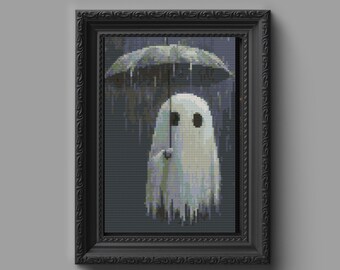 May include: A framed cross-stitch artwork featuring a white ghost standing in the rain under a gray umbrella. The ghost has two dark circular eyes and is depicted against a dark, pixelated background representing a rainy atmosphere.