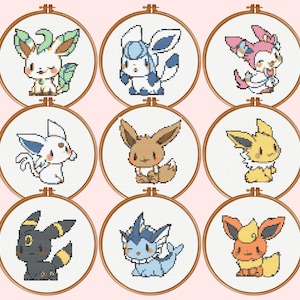 May include: Nine circular wooden embroidery hoops containing cross-stitch patterns of various fictional creatures. Each hoop features a unique character with distinct colours including brown, yellow, blue, pink, and black, displayed in a grid layout.