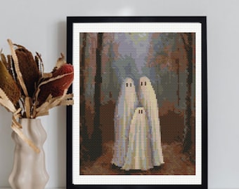 May include: A framed cross-stitch pattern featuring three white ghosts standing in a dark, wooded forest. The ghosts are depicted with simple black eyes and are surrounded by brown tree trunks and muted green foliage in a pixelated art style.