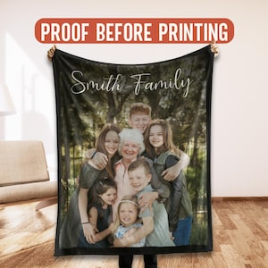 May include: A black blanket featuring a family photo with the words "Smith Family" in a cursive font. The blanket displays a group of people, likely a family, with a forest background. The text "PROOF BEFORE PRINTING" is at the top.
