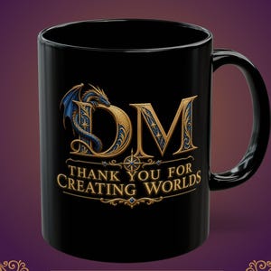 May include: A black ceramic mug featuring a gold and blue dragon graphic wrapped around the letters DM. Below the letters, the text reads THANK YOU FOR CREATING WORLDS in gold lettering. The design includes a compass-like star element.
