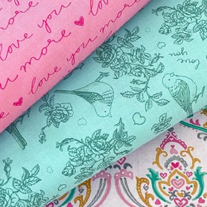 May include: Three fabric swatches with different patterns. One is pink with the words "love you more" and hearts. Another is teal with bird and floral designs. The third is white with a repeating ornate pattern in pink, gold, and teal.