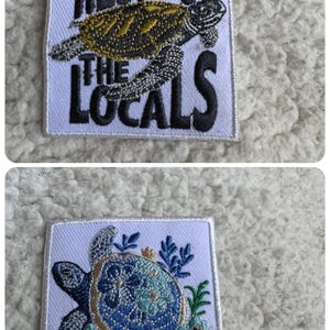 May include: Two embroidered patches with turtle designs. The top patch has a turtle with the text "RESPECT THE LOCALS". The bottom patch features a blue and teal turtle with floral accents. Both patches are on a white background.
