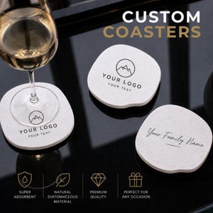 May include: Three white, irregularly shaped coasters with black printed text and graphics. Two coasters feature a mountain logo with the text YOUR LOGO and YOUR TEXT. One coaster displays the script text Your Family Name. A wine glass sits on one.