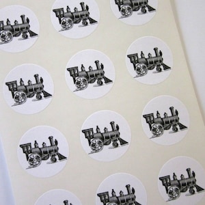 May include: A sheet of 12 round stickers featuring a black and white illustration of a vintage steam locomotive. Each sticker is approximately 2 inches in diameter.