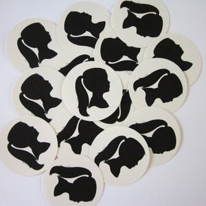 May include: A set of 12 white round stickers with black silhouette images of people with long hair. The stickers are perfect for adding a personal touch to gifts, envelopes, or other items.
