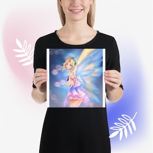 May include: A print featuring a digital illustration of a fairy with blonde hair, blue wings, and a purple and pink dress. The fairy is set against a blurred blue and pink background. The print is held by a person.