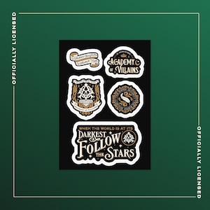 May include: A black sticker sheet featuring six unique designs with white borders. The stickers include phrases like "Academy of Villains" and "Follow the Stars," along with decorative crests and emblems in gold and white.