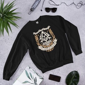 Academy of Villains Crest Unisex Sweatshirt | Officially Licensed Book Merch
