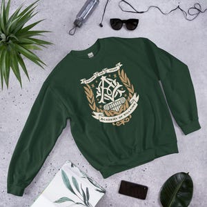 Academy of Villains Crest Unisex Sweatshirt | Officially Licensed Book Merch