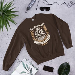 Academy of Villains Crest Unisex Sweatshirt | Officially Licensed Book Merch