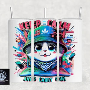 May include: White tumbler with a colorful graphic of a cartoon cat wearing a hat and sitting in front of a laptop. The text "Keep Calm and Carry On!" is printed on the tumbler.