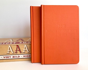 Set of 2 unused 1960s K&E Mining Transit books, bright orange small hardbound notebooks in mint condition