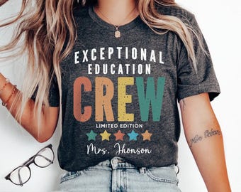 May include: A grey t-shirt with the text "Exceptional Education Crew" in rainbow colours. The text "Limited Edition" is below the crew text, and five yellow stars are below that. The text "Mrs. Jhonson" is at the bottom of the shirt.