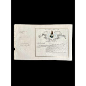 May include: An antique J.I. Case Threshing Machine Company preferred stock certificate. The document features ornate text and an eagle emblem. The certificate is printed on aged paper with a faded appearance, suggesting its age.