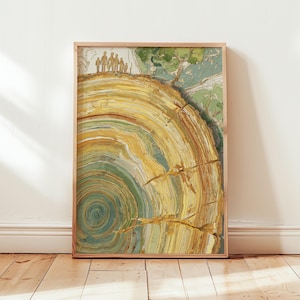 May include: A framed art print featuring a cross-section of a tree trunk with concentric rings in shades of yellow, green, and brown. The artwork has a textured appearance and includes a small group of figures at the top, suggesting scale. The frame is a light wood.