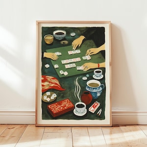 May include: A framed art print depicting a Mahjong game in progress. The scene includes a green game table, hands arranging tiles, and various elements like cups, a red box, and dice. The color palette is dominated by greens, reds, and blues.