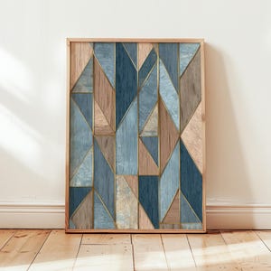 May include: Geometric wooden wall art in a natural wood frame. The artwork features a mosaic of blue, tan, and brown wooden triangles and rectangles, outlined with gold lines. The artwork is displayed on a white wall and wooden floor.