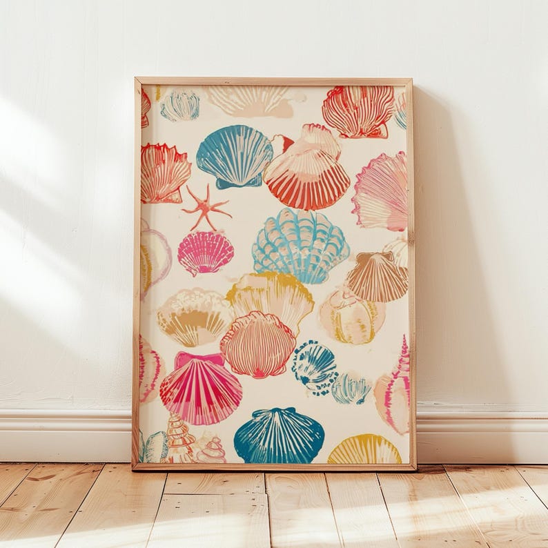 May include: A framed print featuring a pattern of colorful seashells in shades of red, blue, pink, and yellow on a cream background. The artwork includes various shell shapes and a starfish, all within a light wooden frame.