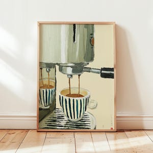May include: An artistic print of an espresso machine pouring coffee into a striped cup. The machine is painted in shades of green and silver, with a cup featuring blue and white vertical stripes. The artwork is framed in a light wood frame.