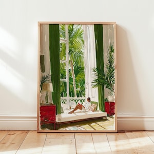 May include: A framed art print depicts a serene interior scene. A person reclines on a daybed, reading a book, with a lush green outdoor view through a large window. The room features red side tables, green curtains, and a lamp.