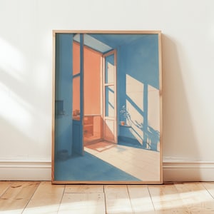 May include: A framed art print showing an interior scene with a doorway and window. The room is painted in blue, with the doorway and sunlight in warm orange tones. A small plant sits on a windowsill.