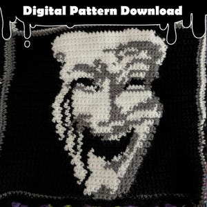 May include: A crocheted square featuring a smiling face design in white, gray, and black. The text "Digital Pattern Download" is at the top. The design is a digital pattern for crochet projects.