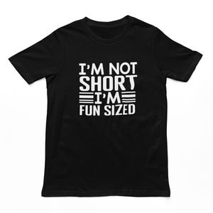 May include: Black t-shirt with white text that reads "I'm not short I'm fun sized".