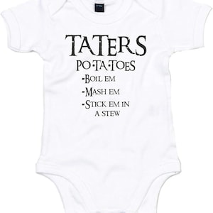 May include: White baby onesie with black text that reads "TATERS POTATOES -BOIL EM -MASH EM -STICK EM IN A STEW". The onesie has short sleeves and snaps at the bottom. The text is in a bold, stylized font.