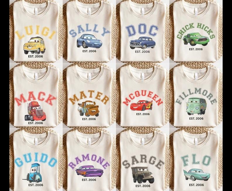 May include: A selection of beige t-shirts, each adorned with a cartoon car character's name in a collegiate style. The shirts also feature an image of the car and the text "EST. 2006". Characters include Luigi, Sally, Doc, and Chick Hicks, among others.