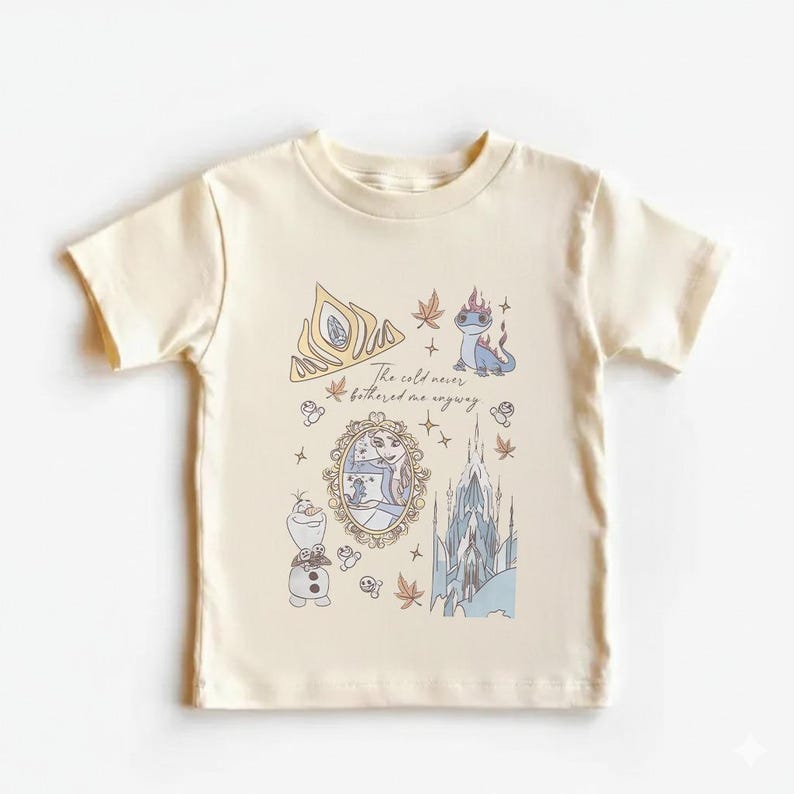 Puede incluir: Camiseta color crema con una ilustraci&oacute;n caprichosa con elementos de la pel&iacute;cula Frozen. El dise&ntilde;o incluye una corona, un castillo, Olaf y el texto "The cold never bothered me anyway."