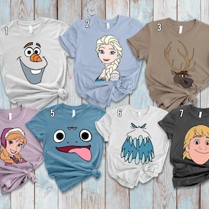 May include: Seven short-sleeved t-shirts with cartoon character designs. The shirts are various colors, including white, light blue, brown, purple, and charcoal. Each shirt features a different character face from a popular animated movie.