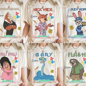 May include: Off-white t-shirts featuring cartoon characters from Zootopia 2. Each shirt has a different character: Winddancer, Nick Wilde, Judy Hopps, Fru Fru, Gary, and Flash. Each design includes the character's name, a carrot, and a police badge.
