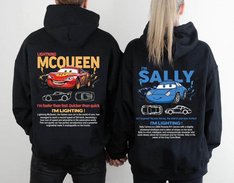 May include: Black hoodies featuring Lightning McQueen and Sally Carrera from the Cars movie. The Lightning McQueen hoodie has a red race car graphic with text. The Sally Carrera hoodie has a blue car graphic with text.
