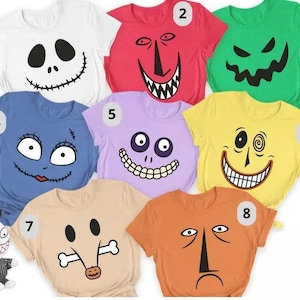 May include: A collection of eight short-sleeved t-shirts in white, red, green, blue, light purple, yellow, beige, and orange, each featuring a unique character face graphic from The Nightmare Before Christmas, numbered one through eight.