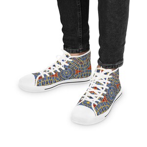 May include: White high-top canvas shoes with a blue and red geometric pattern.