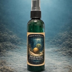 May include: A green bottle with a black spray nozzle. The label features a pineapple illustration with the text "Pineapple Under the Sea." The bottle is labeled "Adopted Acres Soap Co."