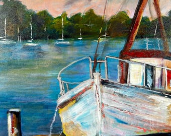 May include: A white sailboat is docked at a pier with a wooden post. The boat is tied to the pier with a rope. The water is blue and there are trees in the background. The sky is cloudy and pink.