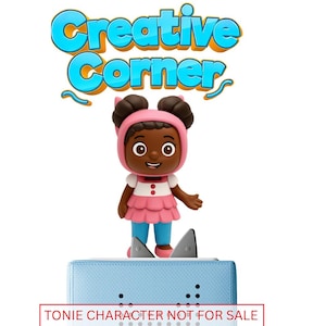 May include: A figurine of a girl wearing a pink hooded outfit and a pink dress, standing on a light blue rectangular base. The words "Creative Corner" are in the top of the image. The text "TONIE CHARACTER NOT FOR SALE GRACIE'S CORNER PLAYLIST ONLY" is at the bottom.