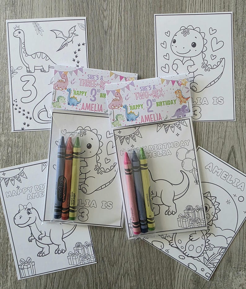 May include: A collection of children's birthday coloring pages featuring dinosaur illustrations. Each page includes the name "Amelia" and the age of the child. Packs of crayons are included with some of the coloring pages.