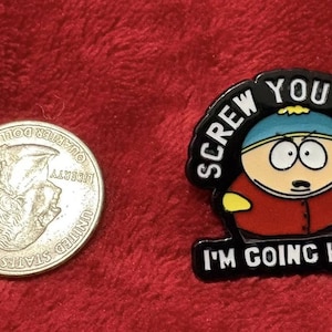 May include: A quarter coin next to a black and red enamel pin featuring a cartoon character with the text "SCREW YOU GUYS I'M GOING HOME!" on a red background.
