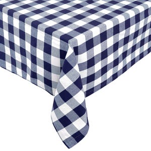 May include: A navy blue and white checkered tablecloth. The fabric is folded over, showing the pattern of large squares. The tablecloth is made of a soft, woven material.