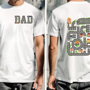 May include: White t-shirt with the word "DAD" printed on the front and a city road map design printed on the back.
