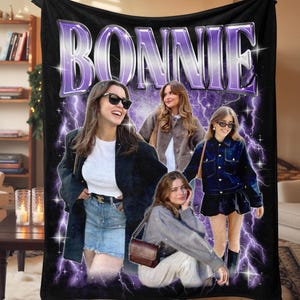 May include: Black fleece blanket featuring a graphic design with the name "BONNIE" in purple text. The design includes four images of a person, with a purple lightning bolt background.