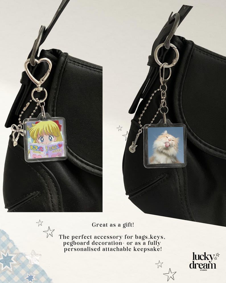 May include: Two square acrylic keychains attached to black bags. One features an anime character reading a book, the other a fluffy cat licking its nose. Both include silver-toned heart or guitar charms and ball chains with metal clasps.