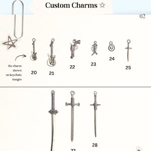 May include: A collection of silver-toned metal charms labeled with numbers 20 through 28, featuring designs of guitars, a revolver, a fish skeleton, a spiral, and various swords. The text Custom Charms is displayed at the top of the image.