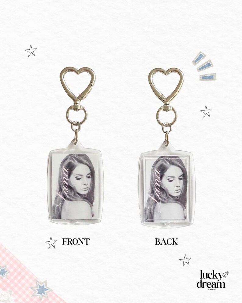 May include: Two rectangular acrylic keychains featuring a black and white portrait of a woman with the text Lana printed vertically. Each keychain has a silver-toned metal heart-shaped clasp and a swivel ring attachment for secure fastening.
