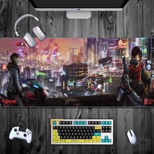 May include: A cyberpunk-themed mouse mat with a cityscape background. The mouse mat features a futuristic city with neon lights and a character holding a gun. The text "Cyberpunk" is visible in the bottom left corner.